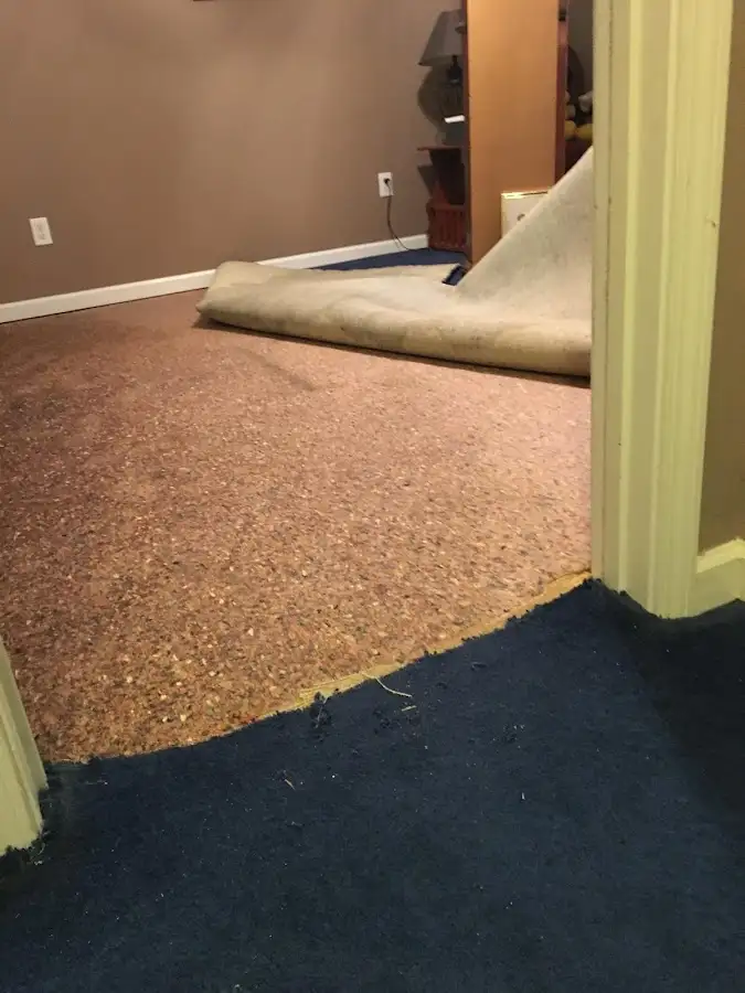 Carpet pad removal revealing water damage during Water Mitigation Services in Ponca City